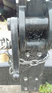 Rainy cobweb over a canal lock mechanism