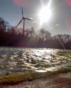 Turbine over gleaming, choppy canal waters